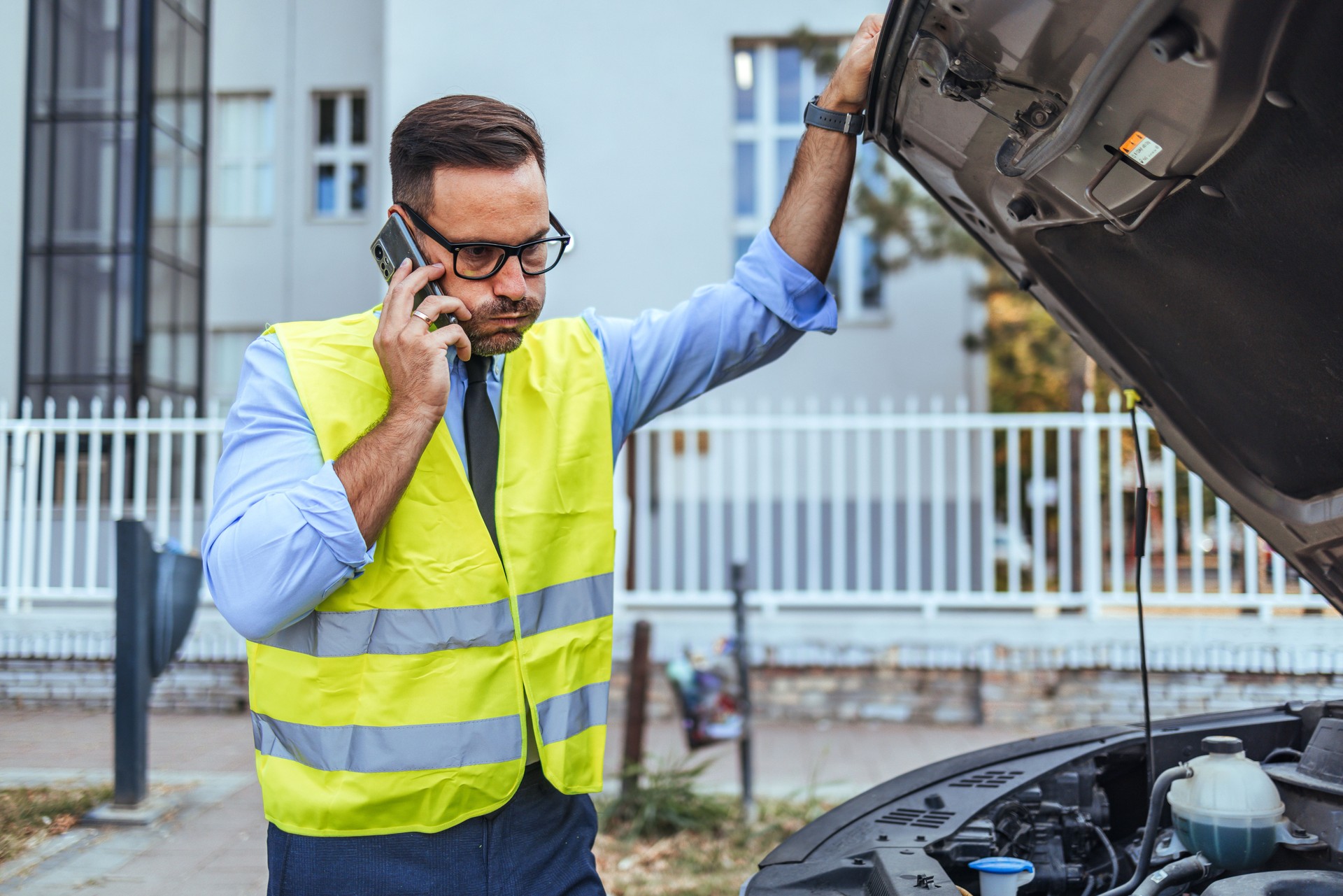 Man in Safety Vest Calling for Roadside Assistance